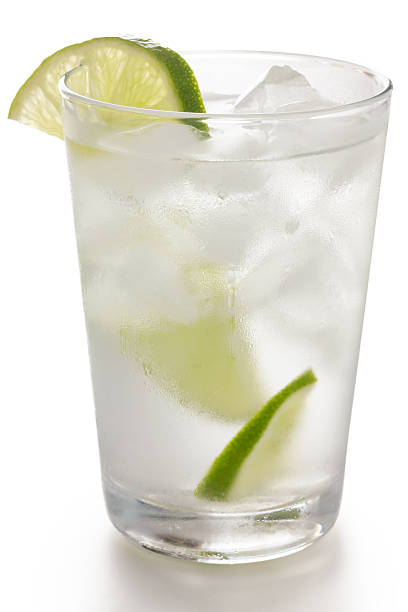 istock Simple glass of water with floating ice cubes and lime 492403193