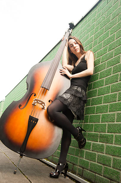 istock musician girl with contrabass 492404555