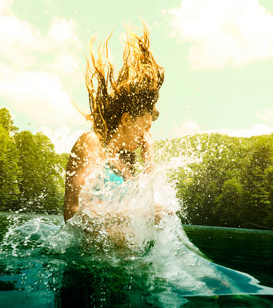 Woman jumping in lake