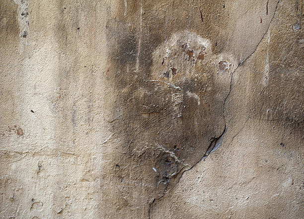 istock Texture of old wall covered with brown stucco 492416774