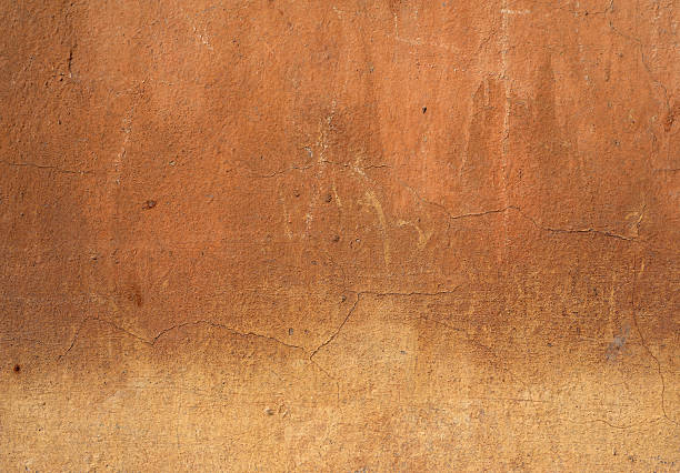istock Texture of old wall covered with brown stucco 492417308