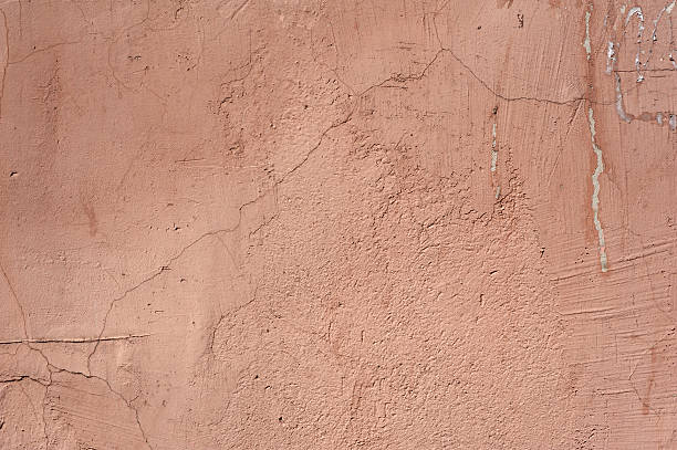 istock Texture of old wall covered with pink stucco 492417434