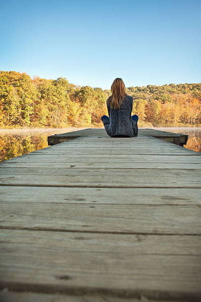 istock Woman Enjoying Fall View From Boat Dock 492419686