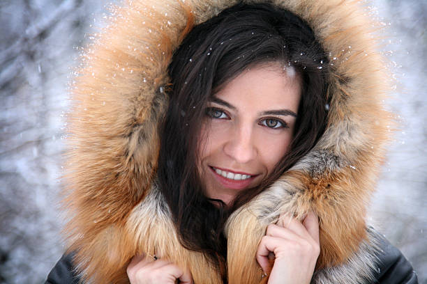 istock Brown hair lady under snowflakes smiling 492419974