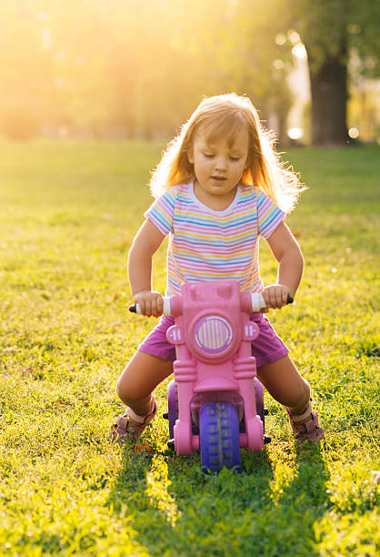 istock Cute young girl running and playing in park 492420804