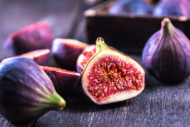 Whole and cut fresh vibrant figs fruit Whole and cut fresh vibrant figs fruit from above fig photos stock pictures, royalty-free photos & images
