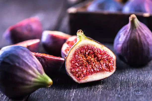 Photo of Whole and cut fresh vibrant figs fruit
