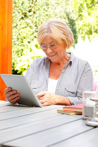 istock Senior woman with digital tablet 492428664