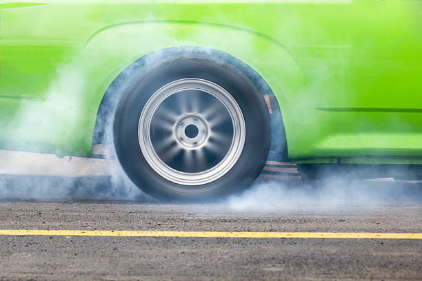 Spinning and burning tyre on asphalt. Quick start with a SUV.