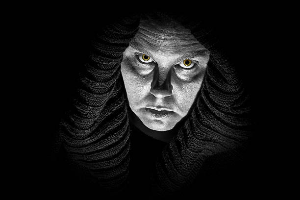 Scary Horror Lady A scary, ugly lady wears a black shroud; glowing monster eyes; black and white image ugly old women stock pictures, royalty-free photos & images