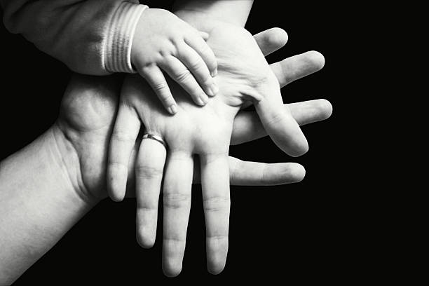 istock Hands of a family black and white 492440617