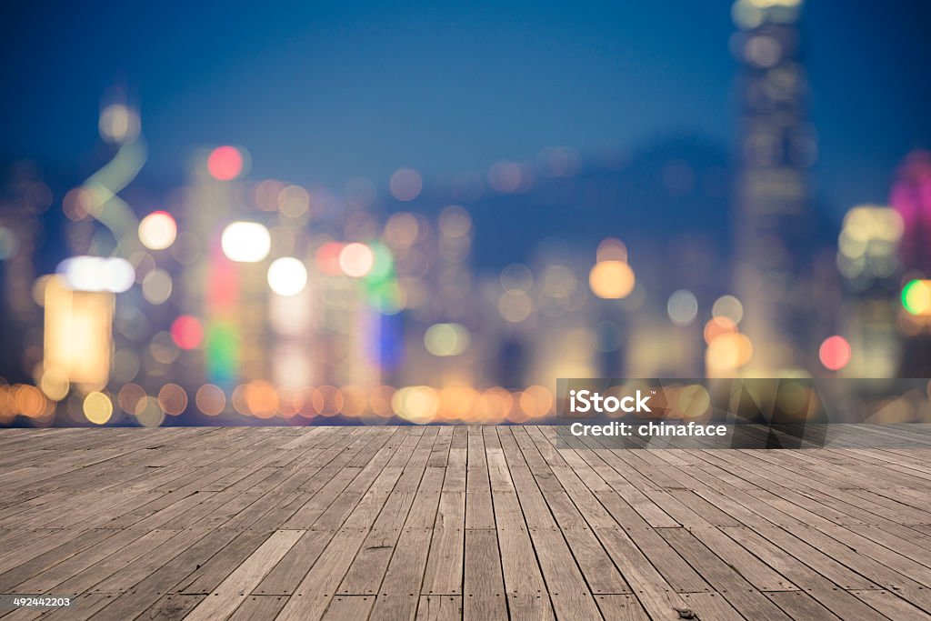 bokeh background  of Hong Kong Cityscape bokeh background  of Hong Kong Cityscape at night. wooden floor in front of. Abstract Stock Photo