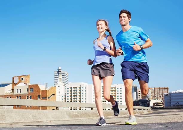 Runners on city road. Running marathon, copy space. Street sprinting outdoor competition. Healthy lifestyle, fitness sport event.