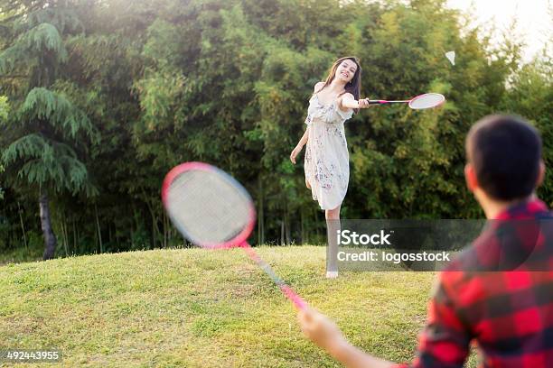 Woman Plays Badminton Against Summer City Park Stock Photo - Download Image Now - Active Lifestyle, Activity, Adult