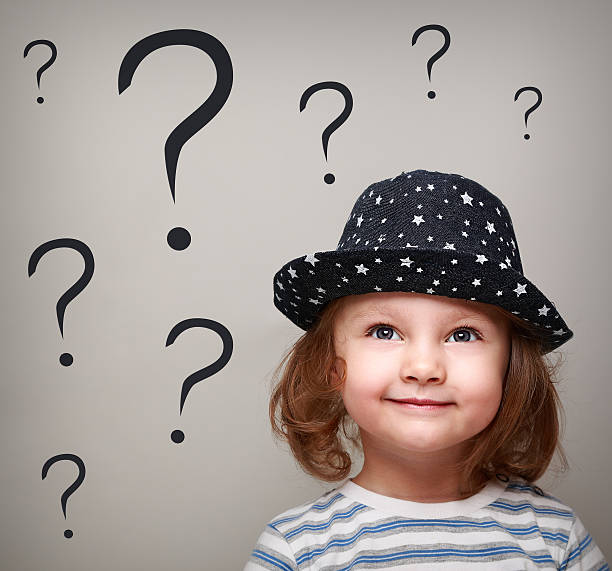istock Happy thinking kid girl in hat looking up on questions 492444207