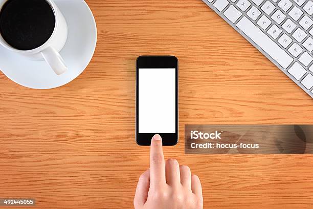 Hand Touching Blank Screen Smart Phone On Business Desk Stock Photo - Download Image Now