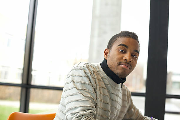 istock Young african american student at library 492446353