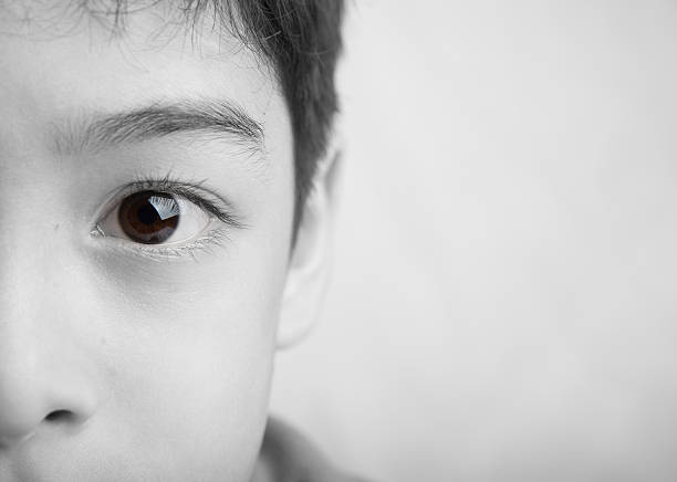 Close up spot color eyes of boy black and white Close up eyes of boy Close up eyes of boy