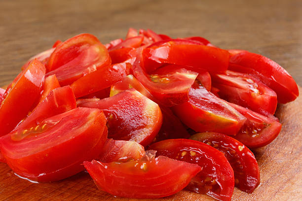 istock fresh red tomatoes, sliced on the chopping board 492451524