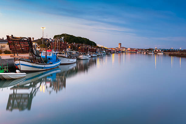 Marano Lagunare, fishing village in Friuli Venezia Giulia View at sunset of the fishing village of Marano Lagunare. Adriatic coast of Friuli Venezia Giulia, Italy. lagoon stock pictures, royalty-free photos & images