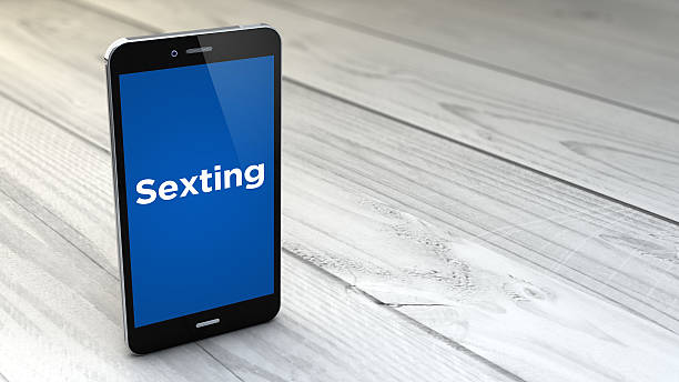 istock sexting smartphone over white wooden background 492456872