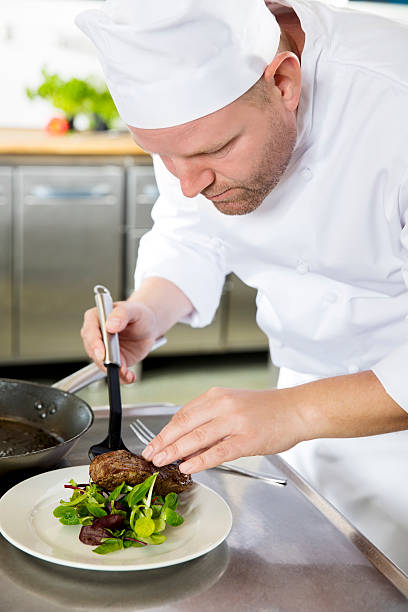 istock Professional chef prepare meat dish at restaurant 492460138