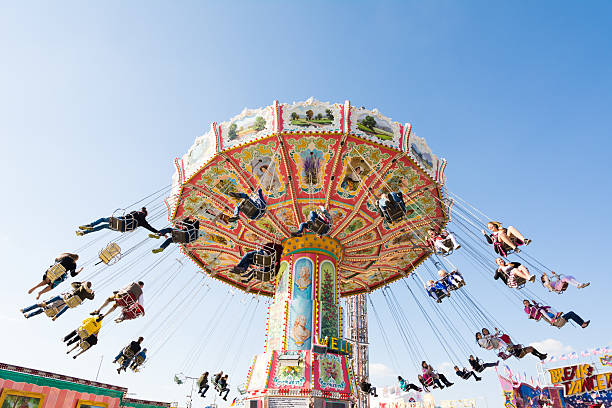 Munich, Germany - September 30, 2015: People in a chairoplane on the Oktoberfest in Munich. The Oktoberfest is the biggest beer festival of the world with over 6 million visitors each year. Foto taken from Theresienwiese.