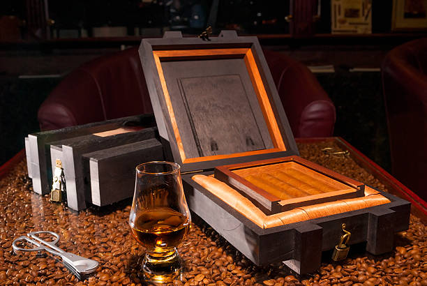 luxury Cuban cigars in a box and  glass of alcohol luxury Cuban cigars in a box and a glass of alcohol cognac region photos stock pictures, royalty-free photos & images