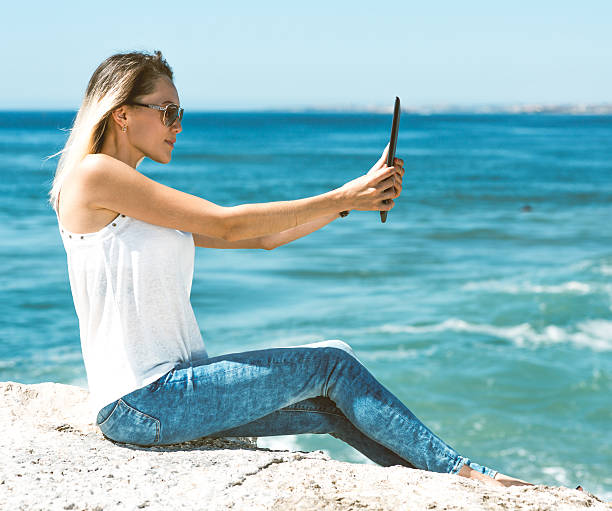 istock Beautiful young woman in real life using tablet PC 492462760