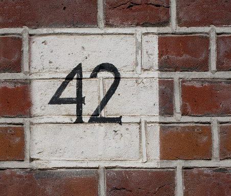 Brick wall with number 42 painted on  the masonry