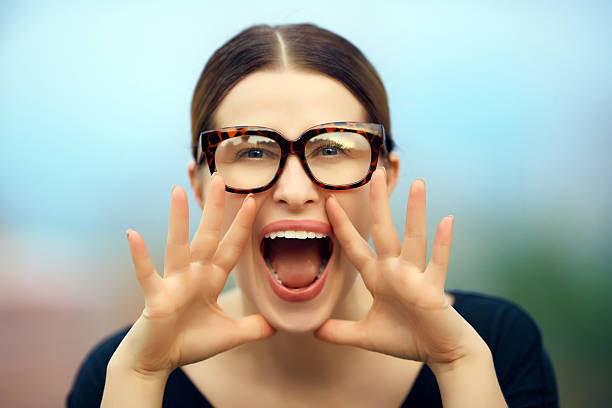 portrait of nerd student with screaming expression, announcing news for you, wearing nerd eyeglasses.