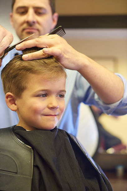 istock Young boy happy to be having his haircut 492483440