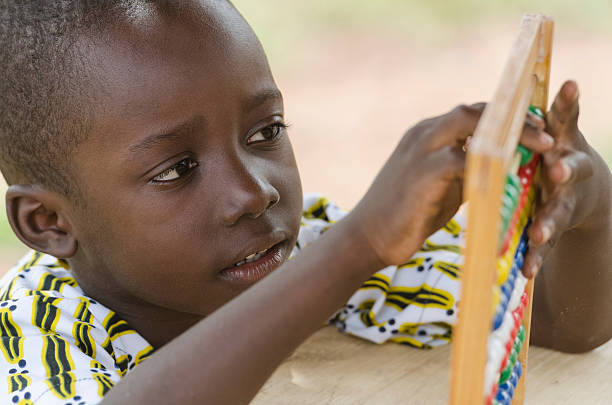istock Black African Boy Learning to Count in Kindergarden (Schooling Symbol) 492483522