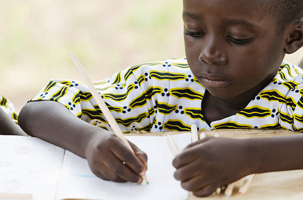 istock Black Boy Drawing and Writing in School 492483700