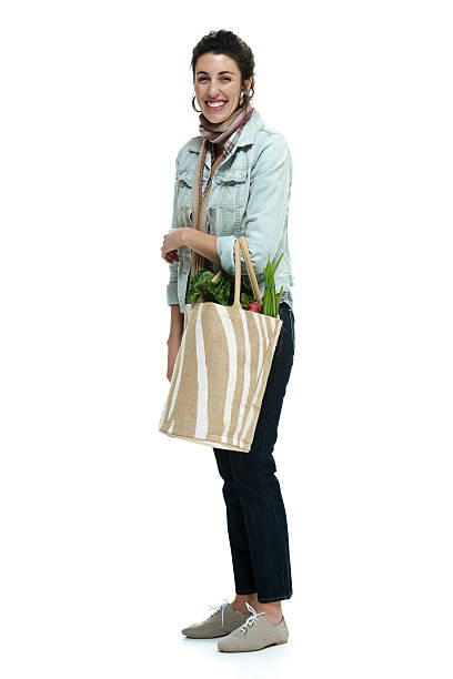 istock Cheerful woman holding vegetable bag 492486414