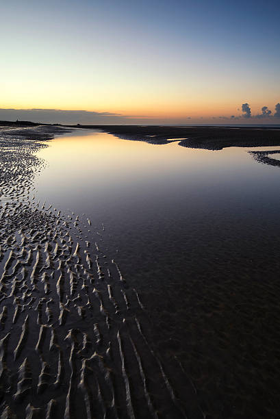 istock Beautiful tranquil sunrise over low tide beach 492486680