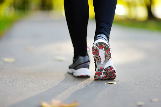 istock Runner feet running on road closeup shoe 492487830