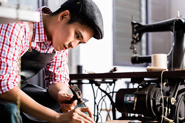 istock Asian shoe or belt maker in his leather workshop 492488398