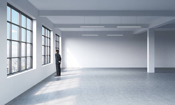 istock man in formal suit who is looking out the window 492490330