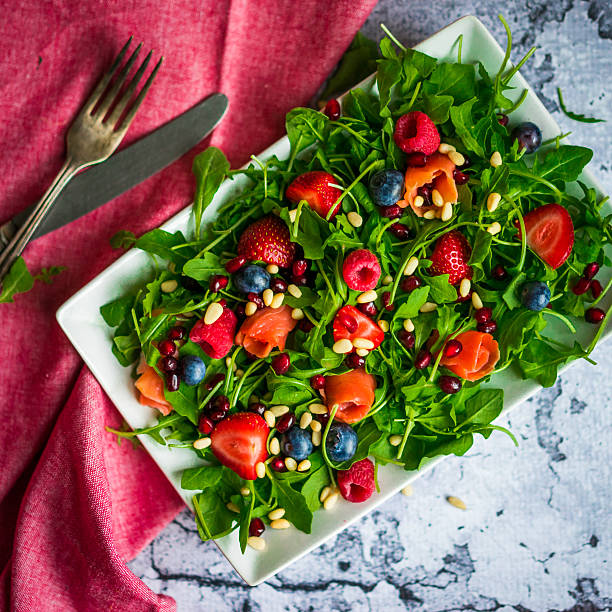 istock Healthy salad with arugula,spinach,smoked salmon and berries 492491990