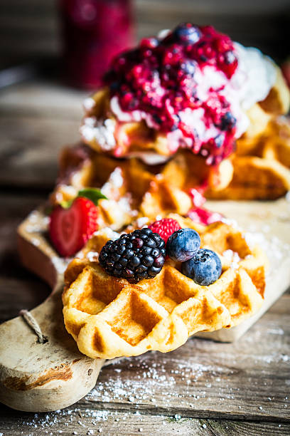 istock Belgian waffles with fresh berries on rustic wooden background 492492306