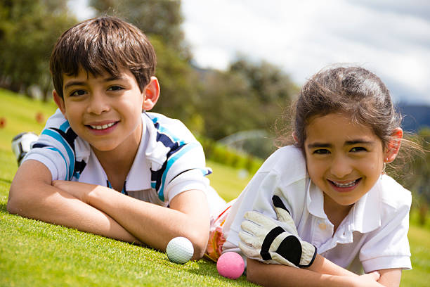 Lovely kids playing golf stock photo