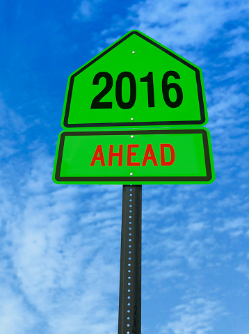 2016 ahead road sign over blue sky with clouds