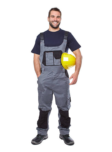 Portrait of smiling worker in gray uniform Portrait of smiling worker in gray uniform isolated on white background electrician smiling stock pictures, royalty-free photos & images