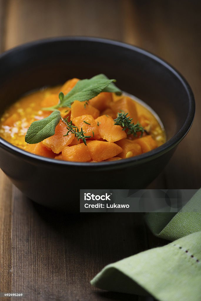 Pumpkin and lentil soup Pumpkin and lentil soup on rustic wooden background Bowl Stock Photo