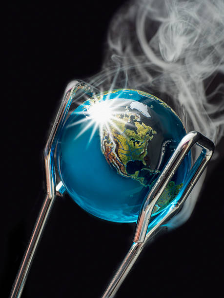 Steaming Planet Earth Held by Tongs Illustrating Global Warming.