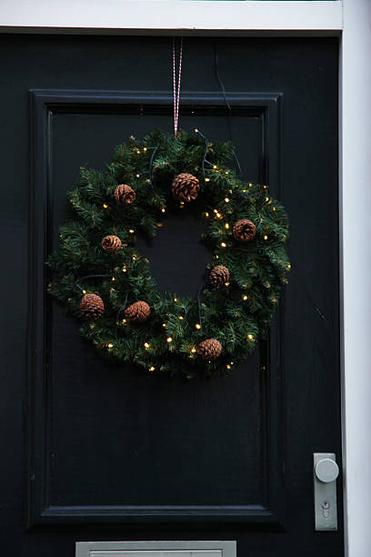 istock Classic christmas wreath with decorations on a door 492496462