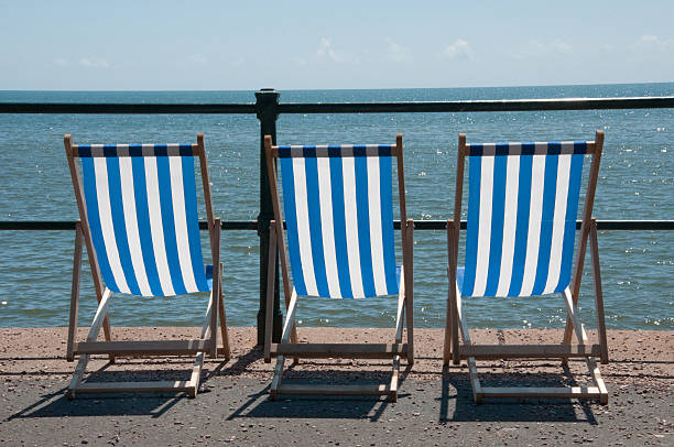 istock Photo of three deckchairs on seaside promenade in UK 492496855