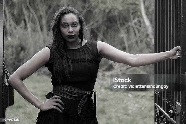 Gothic Lady In Black Holding Gate Stock Photo - Download Image Now - Goth, African Ethnicity, African-American Ethnicity