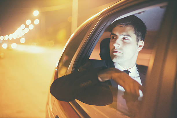 istock Businessman in a car at night 492498246